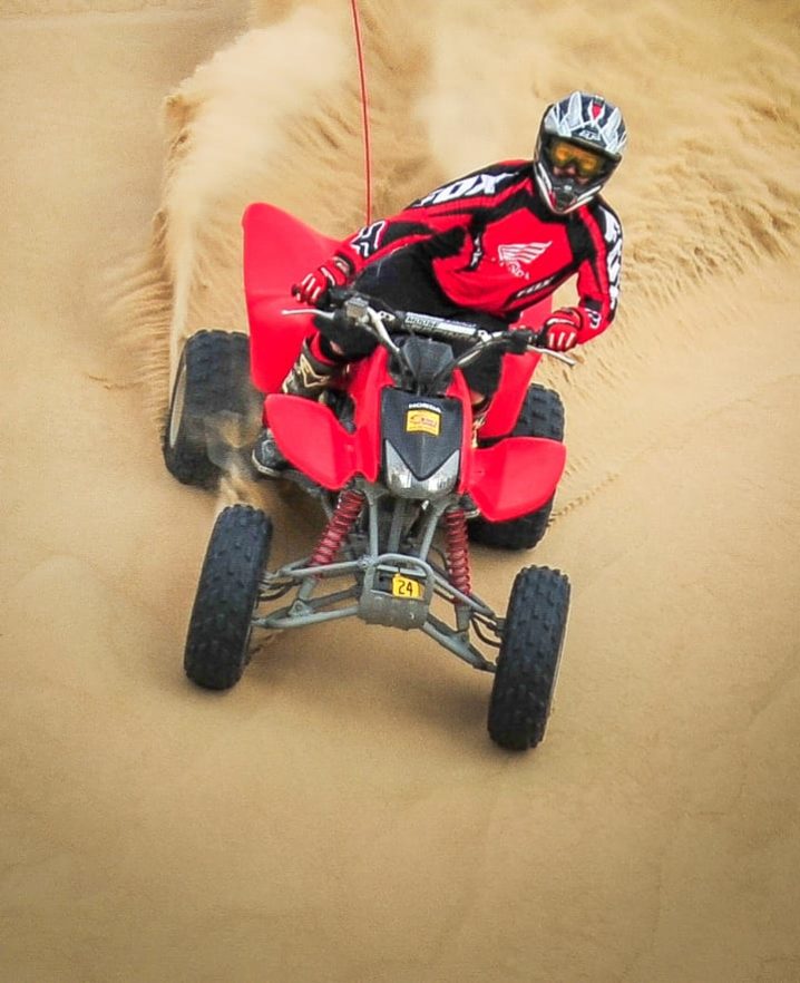 Guest riding downhill on an ATV at Pismo Beach