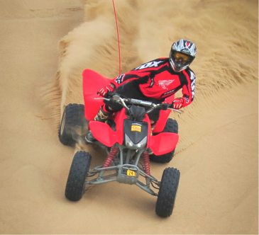 Man riding an ATV downhill
