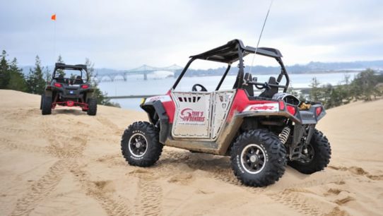 Two ATVs by ocean in Oregon Dunes
