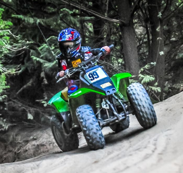 Young child riding a kid's ATV in Oregon