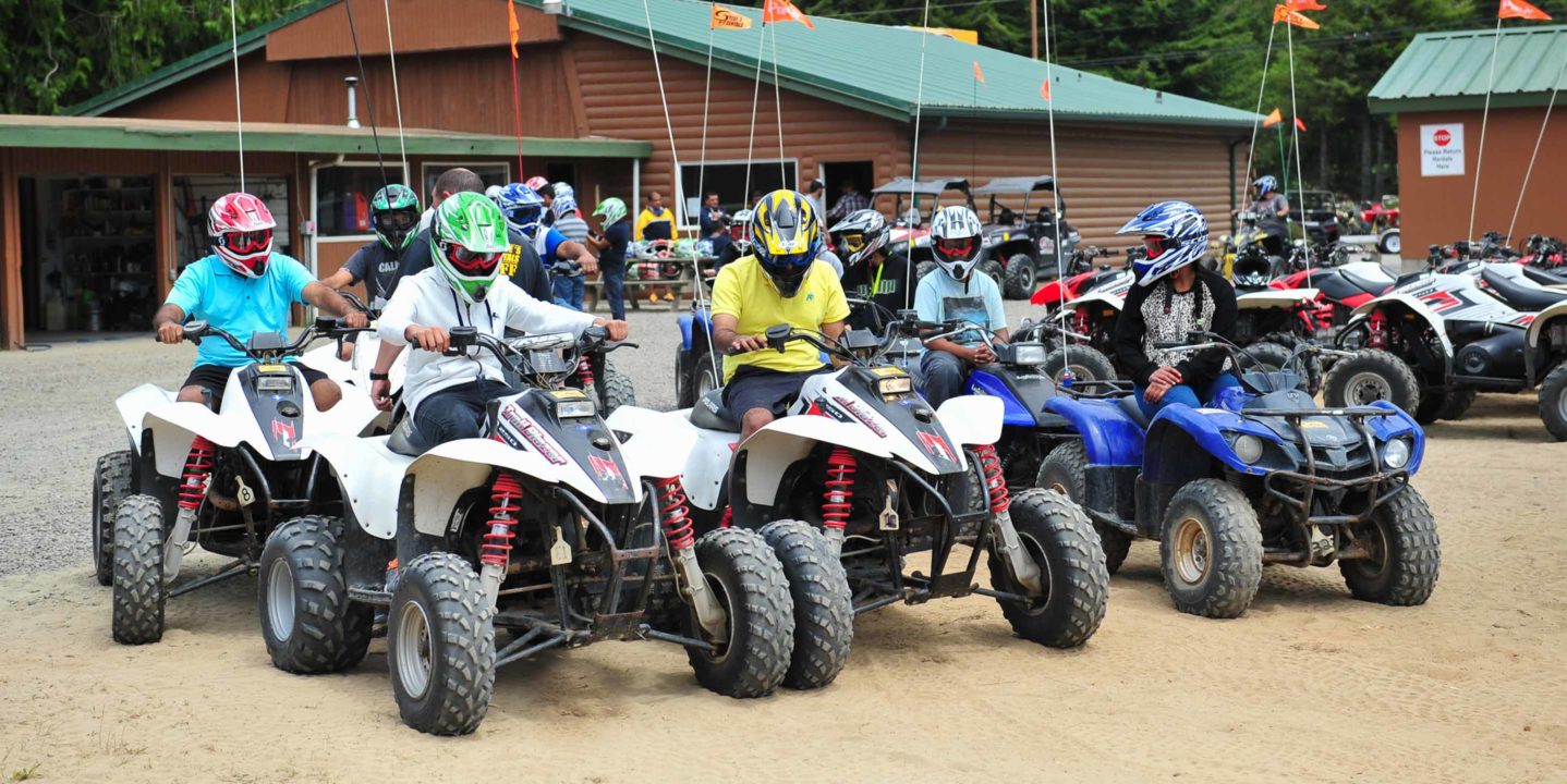 Group of guests sitting on ATV in Oregon, ready to ride