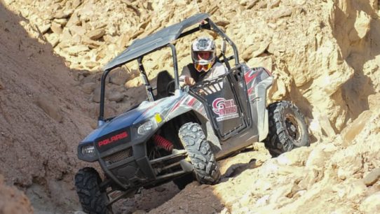 Guest riding an ATV through rocky terrain in Palm Springs