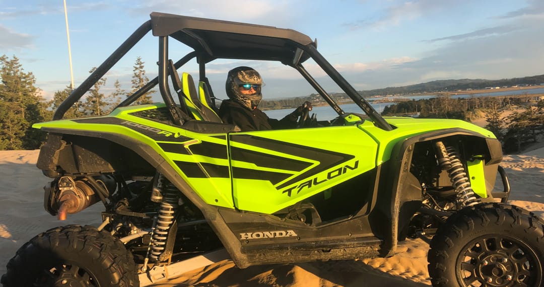Guest riding in a Honda Talon at sunset in Oregon