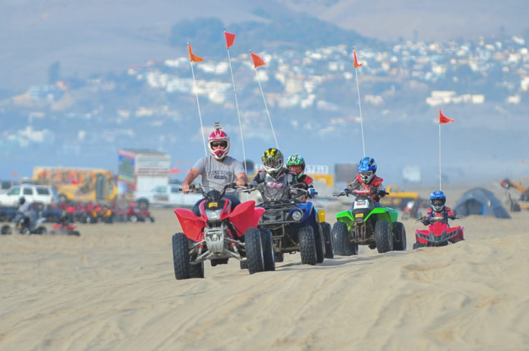 Family riding on colorful ATVs