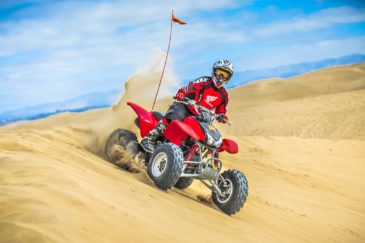 Male guest riding a rental through sand dunes