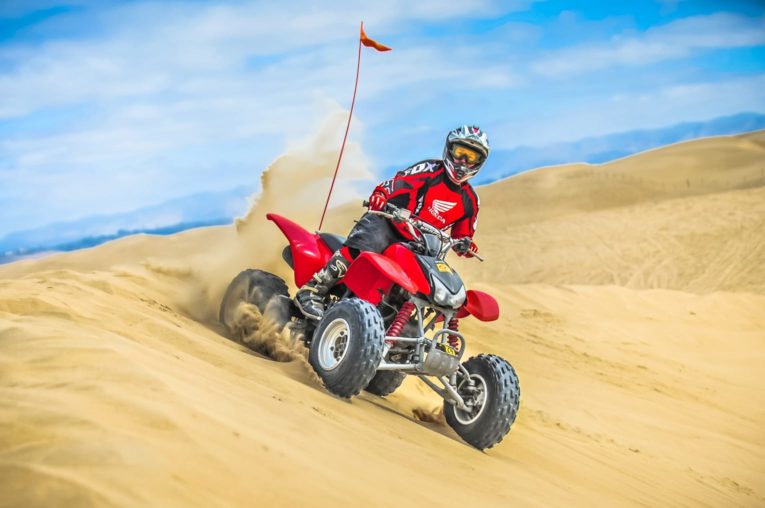 Male guest riding a rental through sand dunes